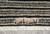 Load image into Gallery viewer, Close-up of a textured rug with geometric pattern on a gray surface