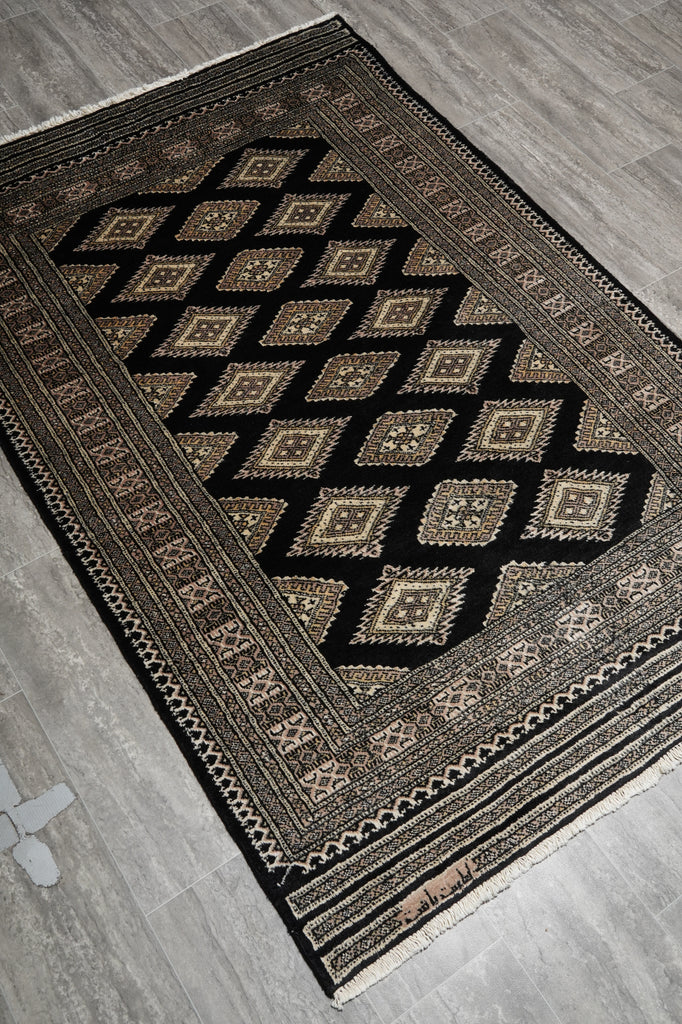 Decorative rug with geometric pattern on a wooden floor