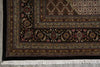 Load image into Gallery viewer, Close-up of a patterned rug with intricate designs on a concrete floor.