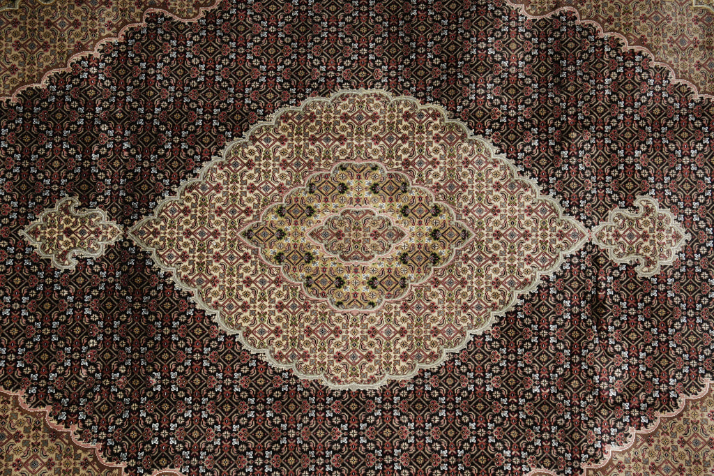 Close-up of a patterned rug with a central diamond design