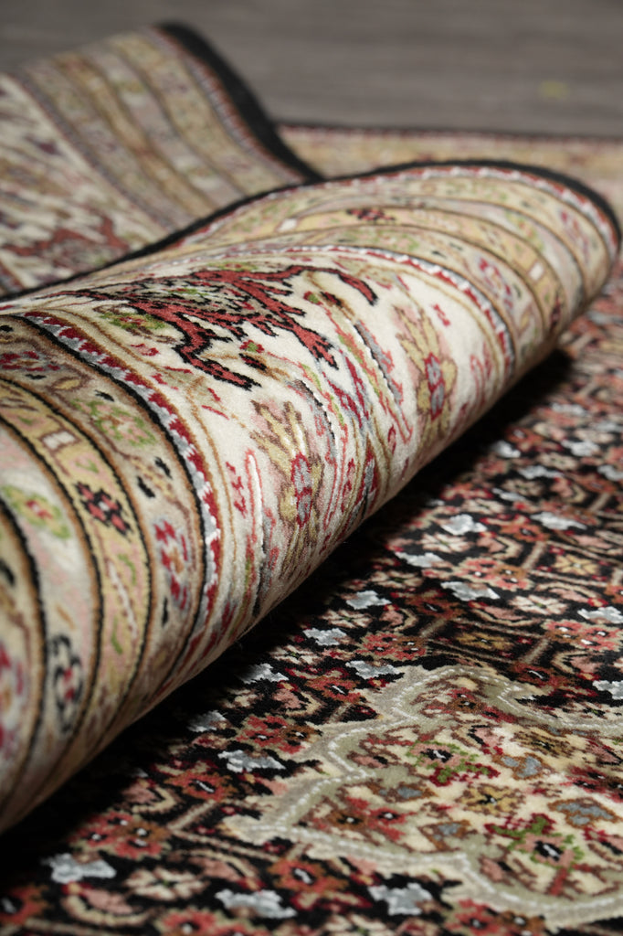 Close-up of a patterned rug with intricate designs.