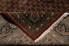 Load image into Gallery viewer, Close-up of a patterned rug with intricate designs and fringes.