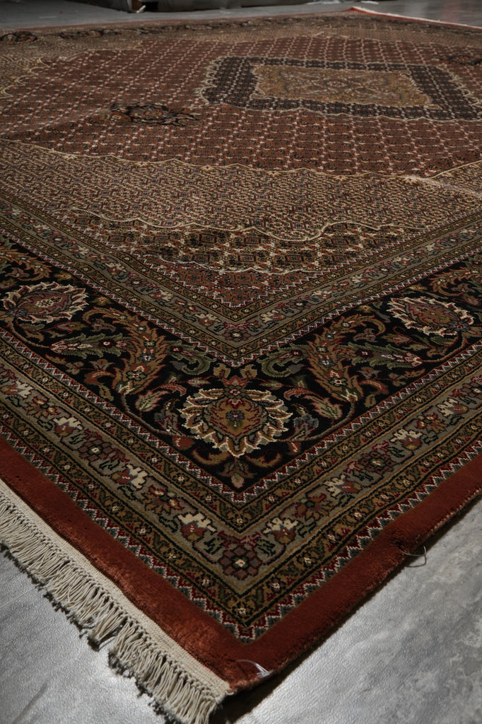 Close-up of a patterned rug with intricate designs on a plain background