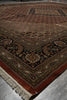 Load image into Gallery viewer, Close-up of a patterned rug with intricate designs on a plain background