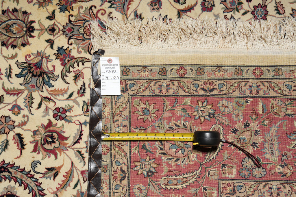 Decorative rug with intricate patterns and a measuring tape for scale.