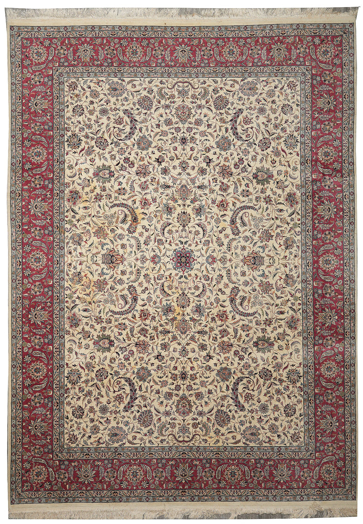 Decorative rug with intricate patterns and a red border on a beige background