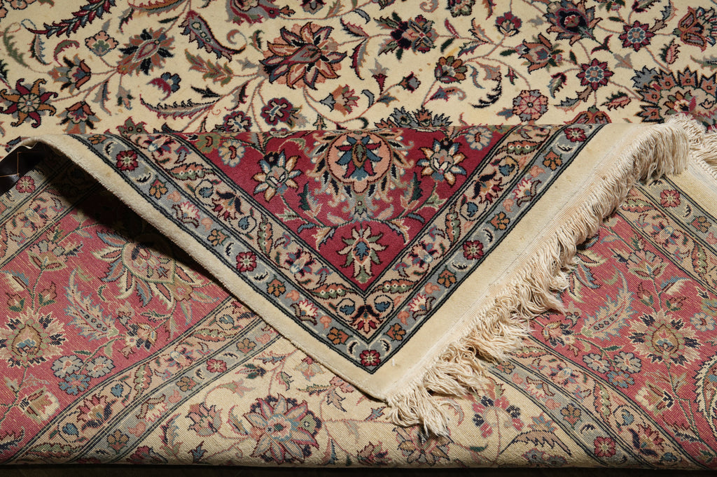 Close-up of a patterned rug with intricate designs and fringes.