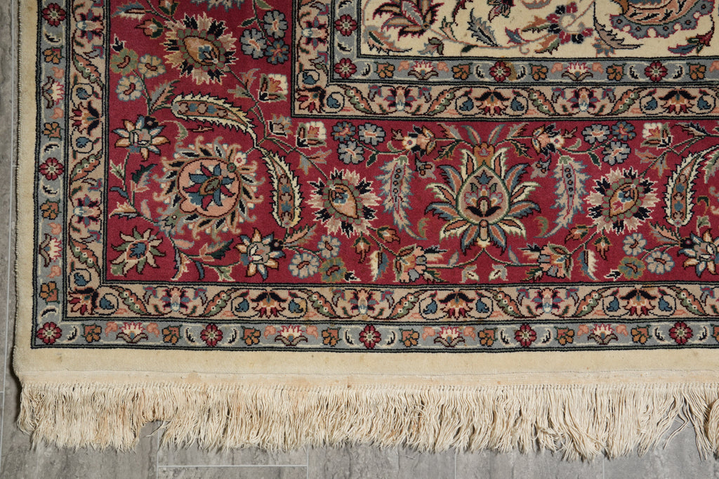 Close-up of a patterned rug with intricate designs and fringes.