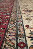 Load image into Gallery viewer, Close-up of a patterned rug with intricate designs on a red and beige background.