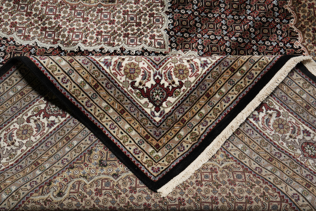 Close-up of a patterned rug with intricate designs.