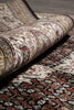 Load image into Gallery viewer, Close-up of a patterned rug with a focus on texture and color.