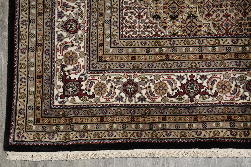 Close-up of an intricately patterned rug with a detailed border.