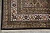 Load image into Gallery viewer, Close-up of an intricately patterned rug with a detailed border.