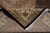 Load image into Gallery viewer, Close-up of a patterned rug with intricate designs and fringes.