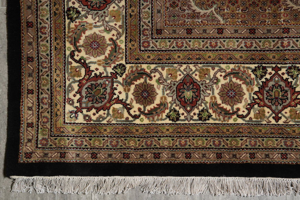 Close-up of a patterned rug with intricate designs on a neutral background