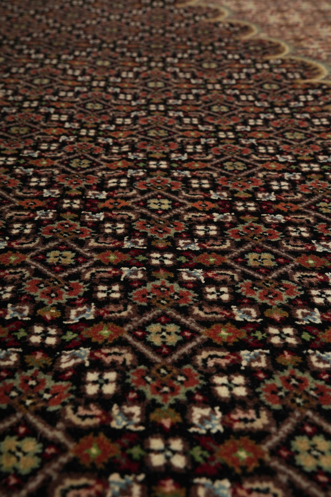 Close-up of a patterned rug with intricate designs.