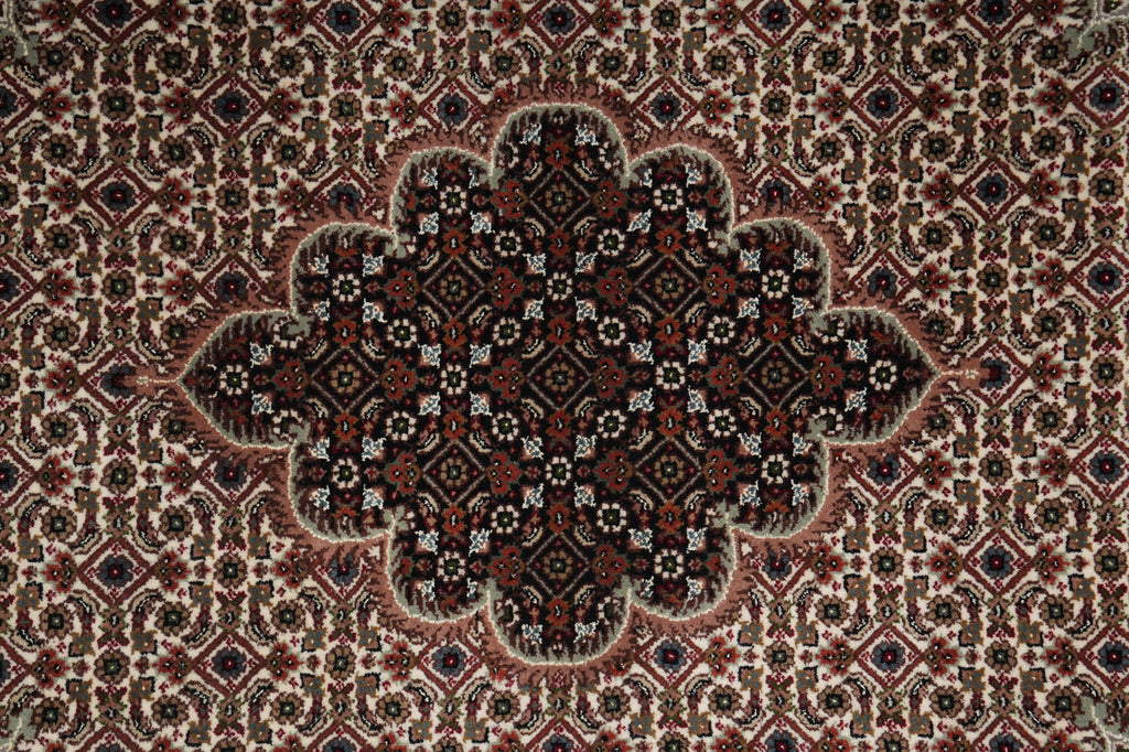 Close-up of a patterned rug with intricate designs.
