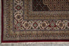 Load image into Gallery viewer, Close-up of a patterned rug with intricate designs and fringes.