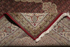 Load image into Gallery viewer, Close-up of a patterned rug with red border and intricate design.