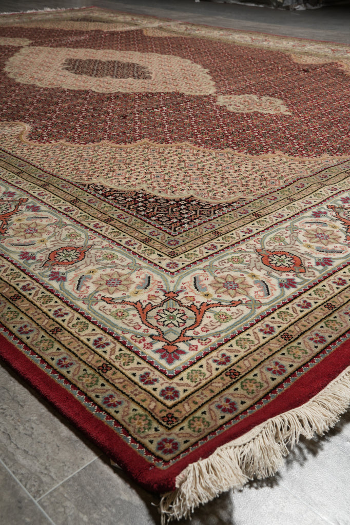 Decorative rug with intricate patterns on a tiled floor