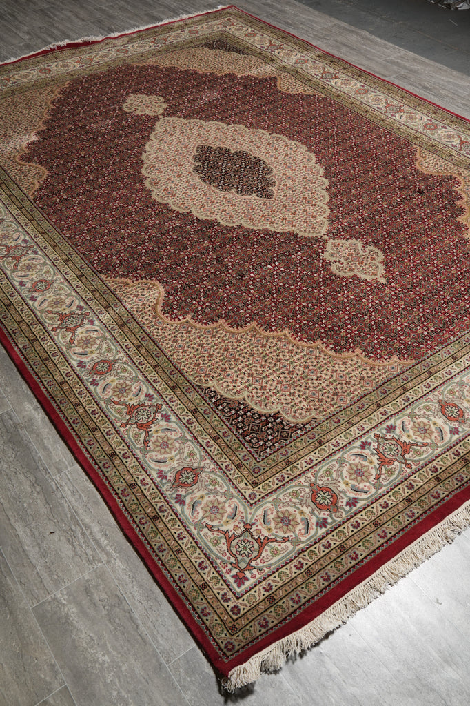 Decorative rug with intricate patterns on a wooden floor