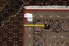 Load image into Gallery viewer, Decorative rug with a measuring tape and a tag on it, placed on another rug.