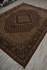 Load image into Gallery viewer, Decorative brown rug with intricate patterns on a gray floor.