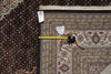 Load image into Gallery viewer, Two patterned rugs with a measuring tape between them, on a checkered floor.
