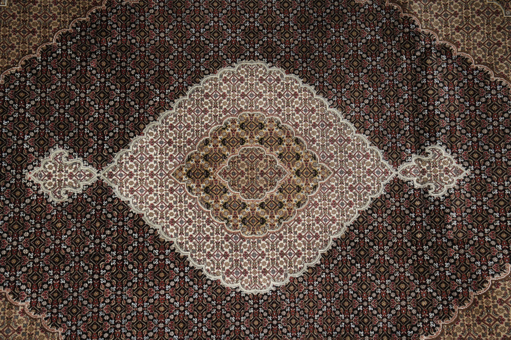 Decorative rug with intricate patterns on a dark background