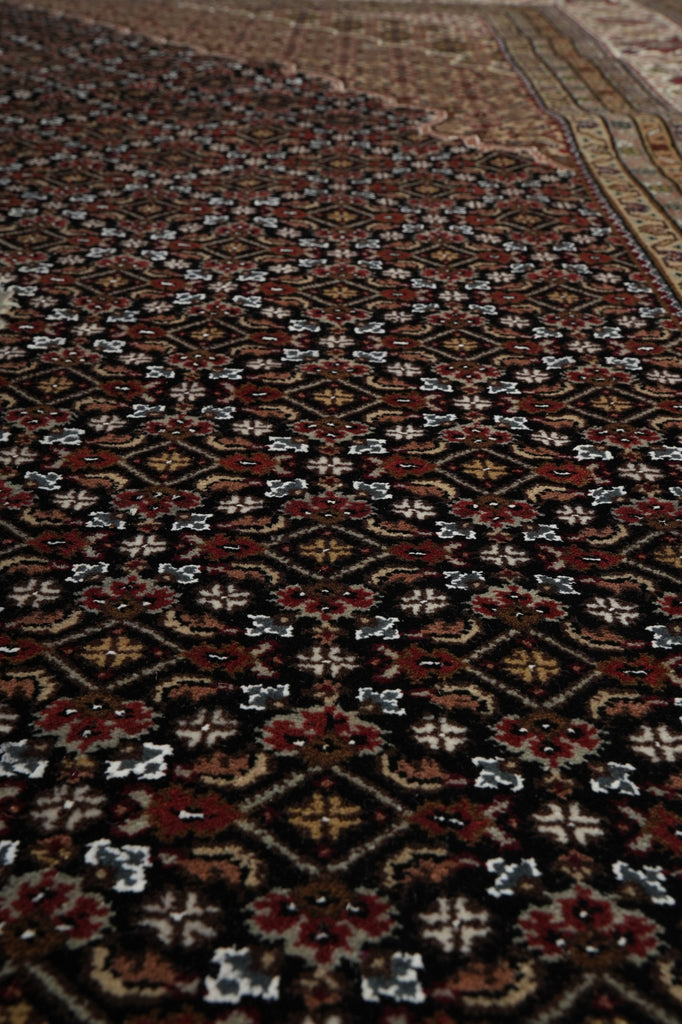 Close-up of a patterned rug with intricate designs.