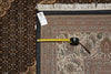 Load image into Gallery viewer, Patterned rug with a measuring tape and a candle on top