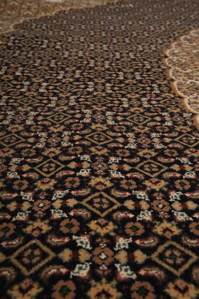 Close-up of a patterned rug with intricate designs.
