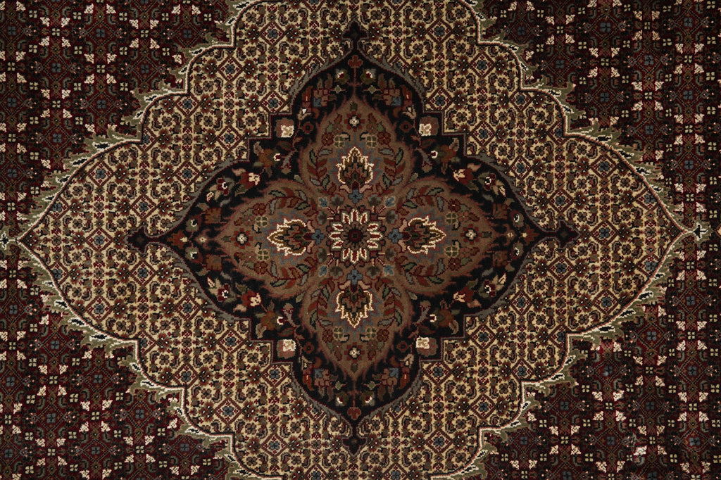 Close-up of a patterned rug with intricate designs.