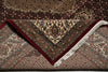 Load image into Gallery viewer, Close-up of a patterned rug with intricate designs and fringes.