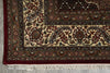 Load image into Gallery viewer, Close-up of an ornate rug with intricate patterns on a concrete floor.