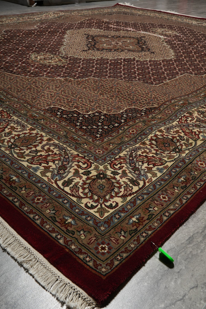 Close-up of a patterned rug with intricate designs on a plain background
