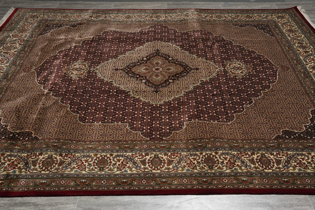 Decorative rug with intricate patterns on a wooden floor