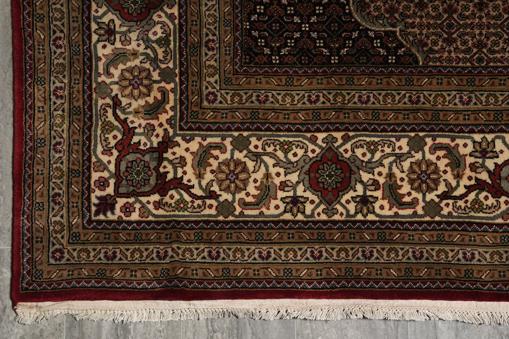 Close-up of an intricately designed rug with detailed patterns on a neutral background