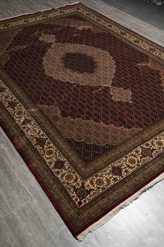 Decorative rug with intricate patterns on a gray floor