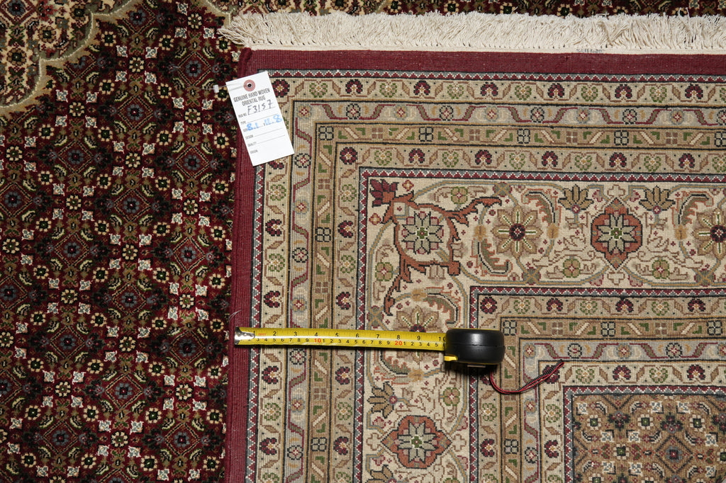Decorative rug with a measuring tape on top, showing measurements.