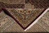 Load image into Gallery viewer, Close-up of a patterned rug with intricate designs and a red border.