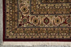 Load image into Gallery viewer, Close-up of a patterned rug with intricate designs on a gray floor.