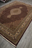Load image into Gallery viewer, Decorative rug with intricate patterns on a wooden floor