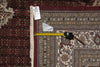 Load image into Gallery viewer, Patterned rug with a measuring tape and a small object on top