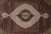 Load image into Gallery viewer, Close-up of a patterned rug with a central medallion design.