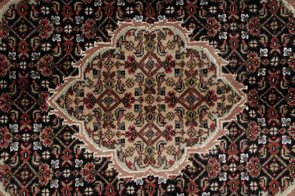 Close-up of a patterned rug with intricate designs.