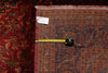 Load image into Gallery viewer, Patterned rug with a measuring tape and price tag on a dark background