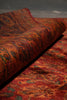 Load image into Gallery viewer, Close-up of a textured red fabric with intricate patterns