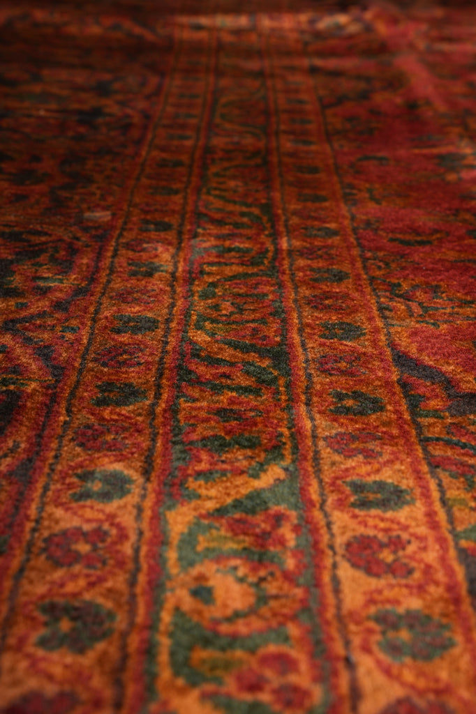 Close-up of a patterned fabric with red and black colors.