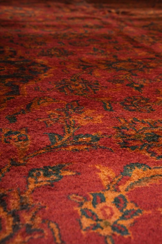 Close-up of a red patterned rug with intricate designs.